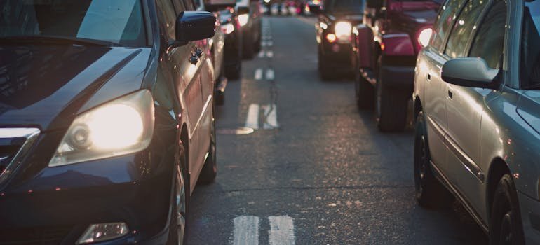 A close-up view of cars stuck in heavy traffic on a city street, showing headlights and congested lanes.
