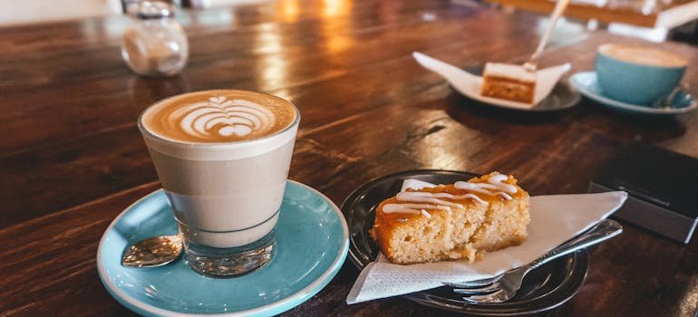 A coffee and a pastry on the table