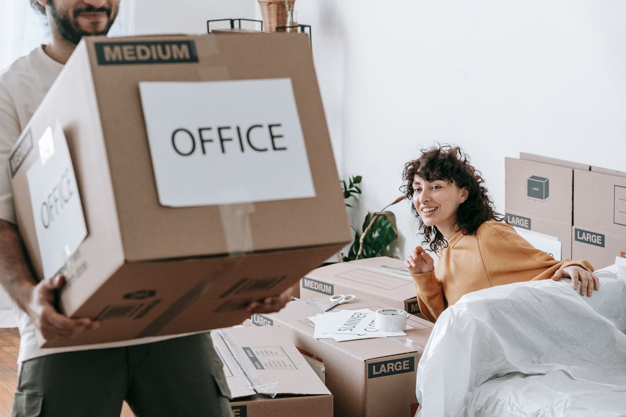 A man carrying a box labeled office