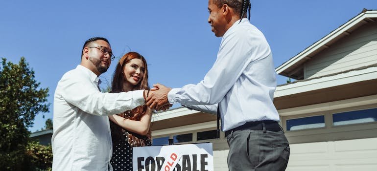 A couple with the real estate agent discussing buying a home in San Antonio vs neighboring cities