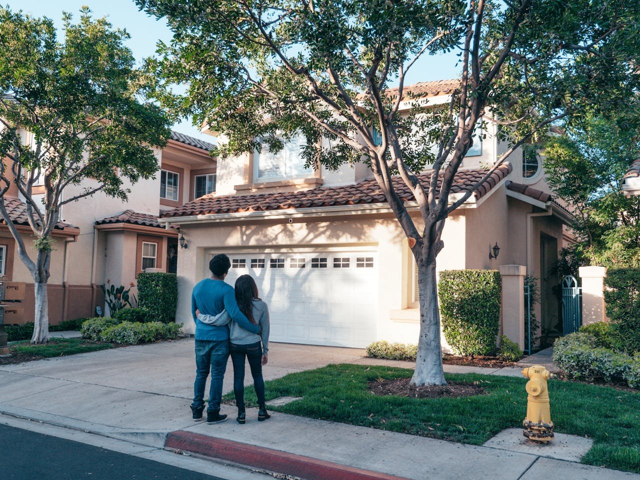 A couple who just started living in Olmos Park in front of the house