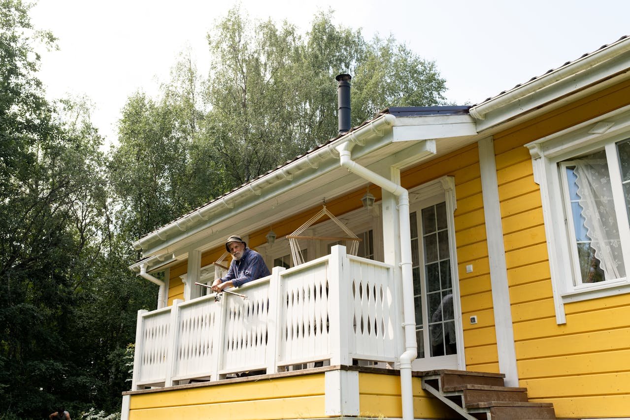 A senior man standing on the porch