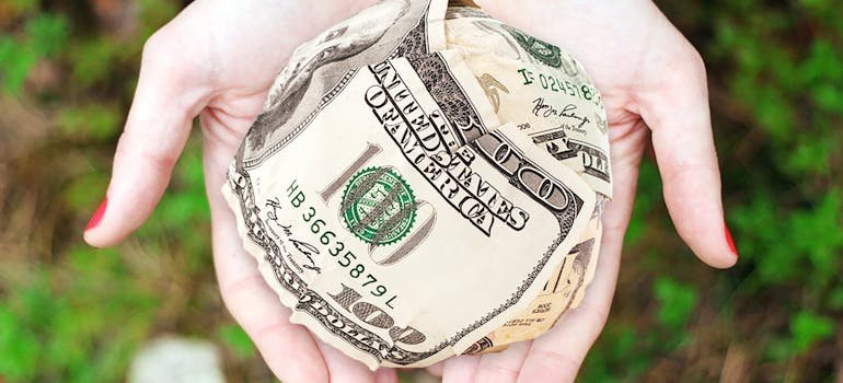 A person holding dollar bills
