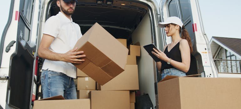A mover and a woman loading boxes