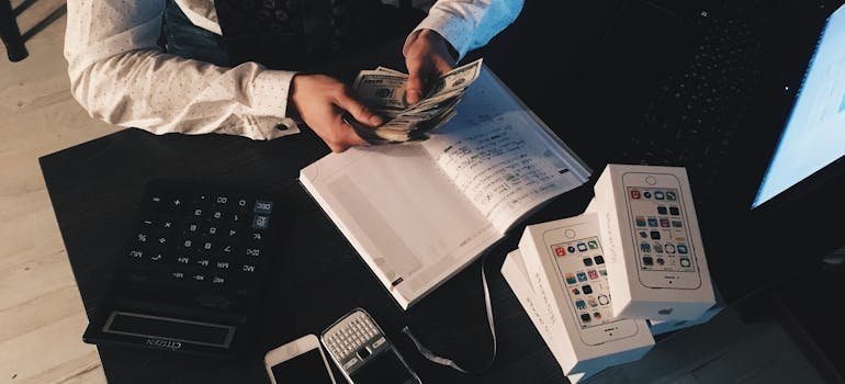 A person counting dollar bills 