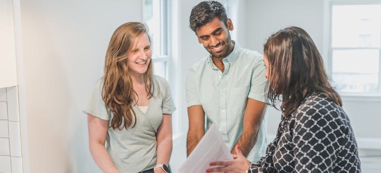 A couple talking with the real estate agebt about the benefits of living in a smaller home in Floresville