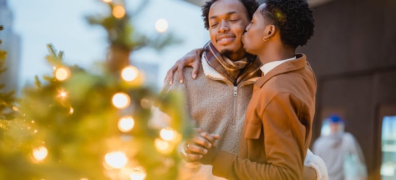 A couple next to the Christmas Tree