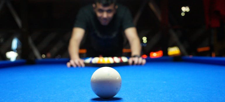 A man next to the pool table 