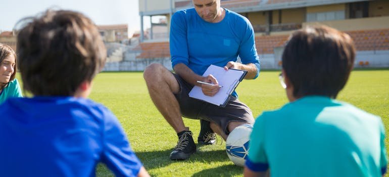 A man coaching a group of kids
