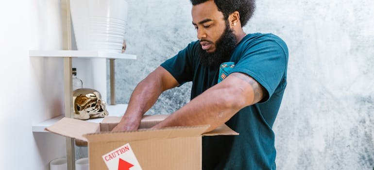 A mover packing a moving box