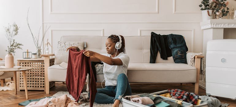 A woman unpacking a suitcase