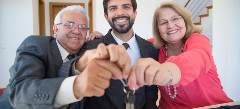 A senior couple holding house keys 