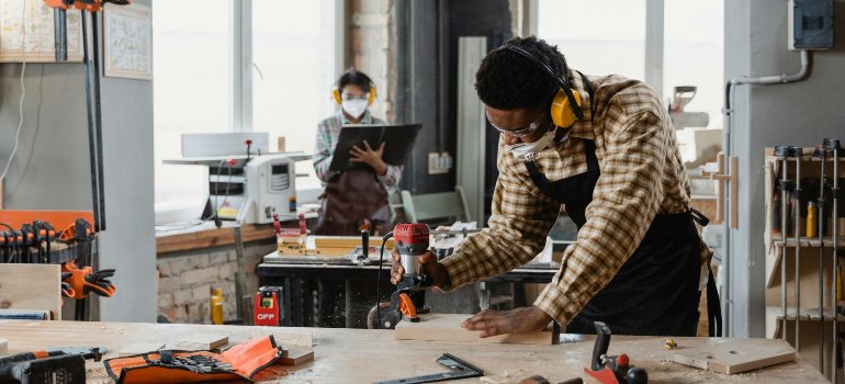 Entrepreneur using tools in a workshop, representing startup growth in cities near San Antonio for young entrepreneurs.