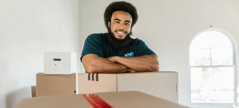 A mover leaning on a box.