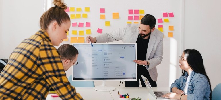 People in a meeting discussing how to keep your office move on schedule