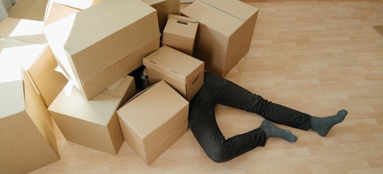 a person buried under the boxes