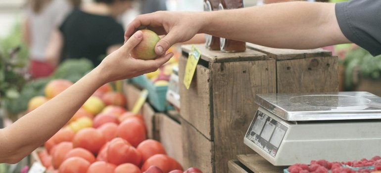 Person Giving Fruit to Another