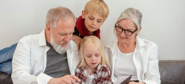 Grandparents with their grandchildren Looking at a Album