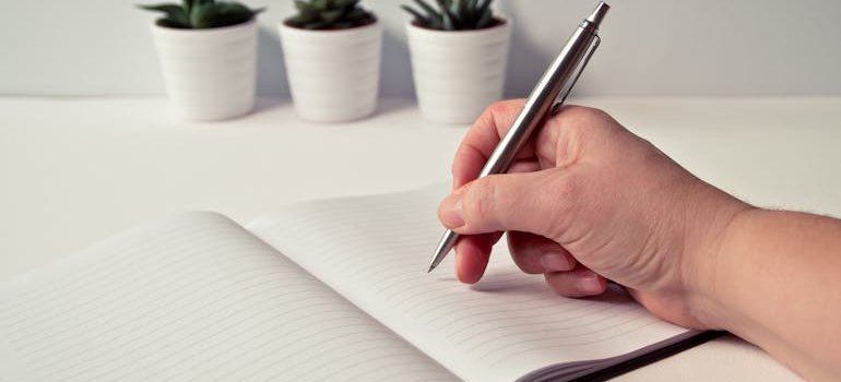 a person writing down a plan for relocating from Converse to Hondo