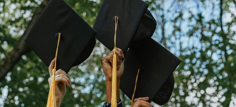 A Group of Person Holding Graduation Cap