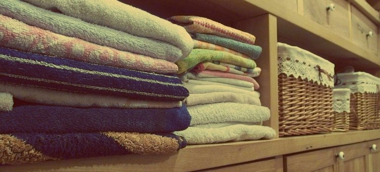 Stack of Towels on Rack Prepared to Pack for a Move When You Have a Toddler at Home