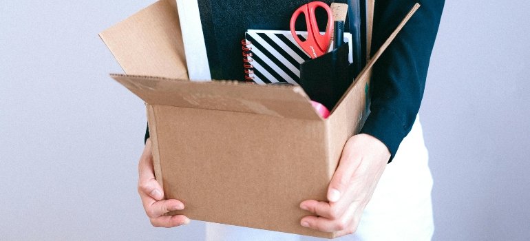 Cardboard box filled with office items, symbolizing the process of Relocating Your Office.