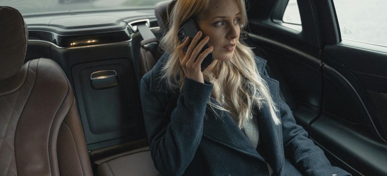 Woman Wearing A Coat Sitting Inside A Car