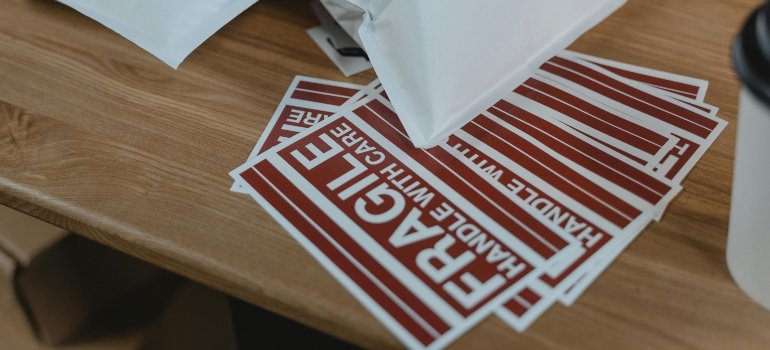 Red fragile stickers ready for duty, because everything is apparently priceless until it hits the truck floor.