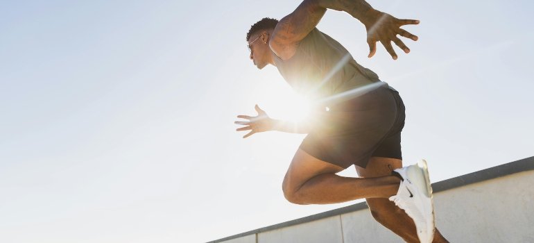 Athletic Man Running on Rooftop at Sunrise