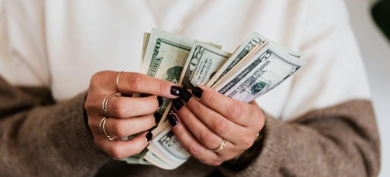 Close-Up Photo of a Person Counting Her Money