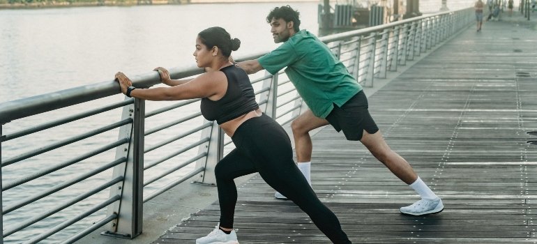 Woman and Man Warming Up on the Boardwalk