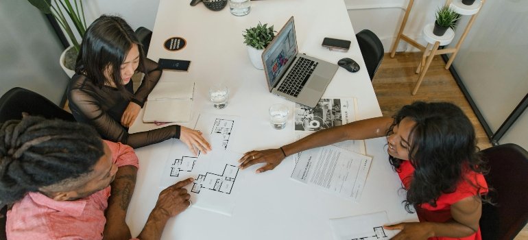 People Brainstorming in Office while planning decluttering your workspace before relocating in San Antonio for a more organized and efficient move