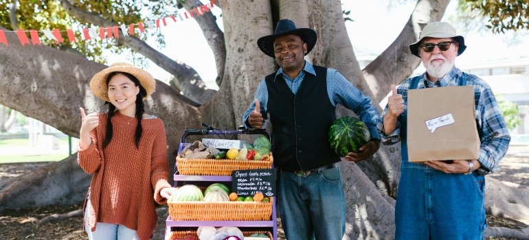 A Group of People Standing Near the Cart with Woven Baskets