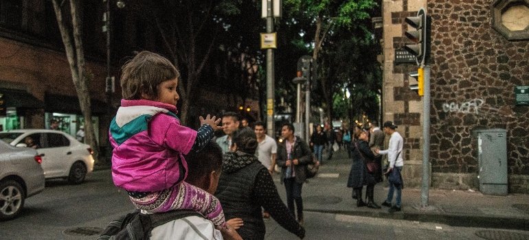 a girl sitting on somebody's back
