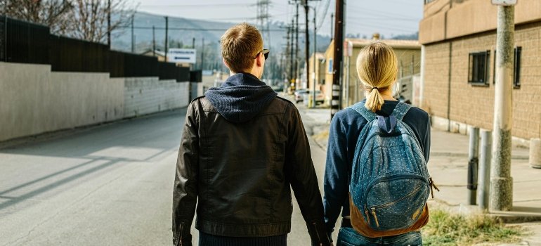 a girl and boy holding hands