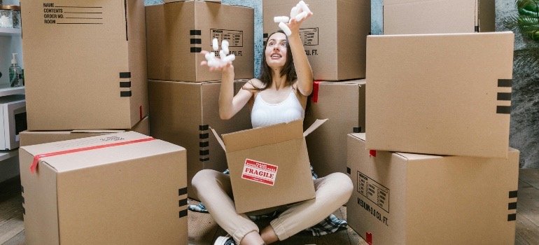 A woman packings, following tips for a successful move from Kerrville to Lytle