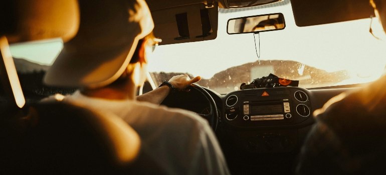 Man Holding the Steering Wheel While Driving