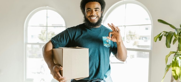 A Man Holding a Cardboard Box