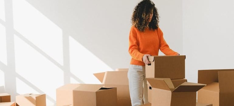 A woman packing boxes for a same-day move in Uvalde. 