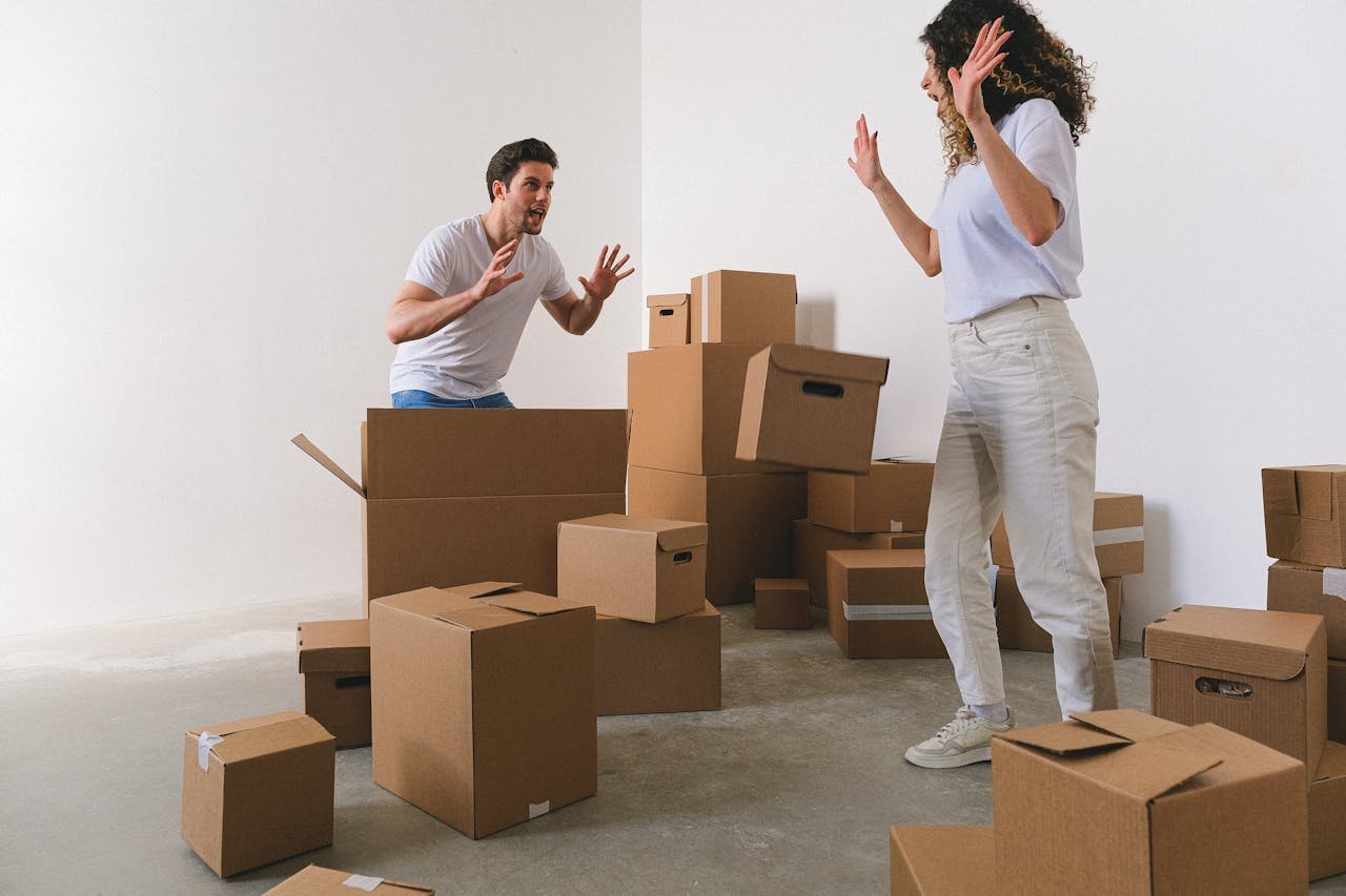 A man and a woman packing fast for the same-day move in Uvalde surrounded with many boxes on the floor.