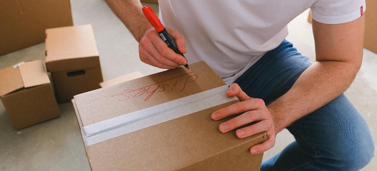 a boy packing moving supplies San Antonio