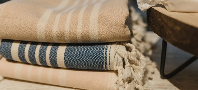 Stack of blankets placed on wooden table
