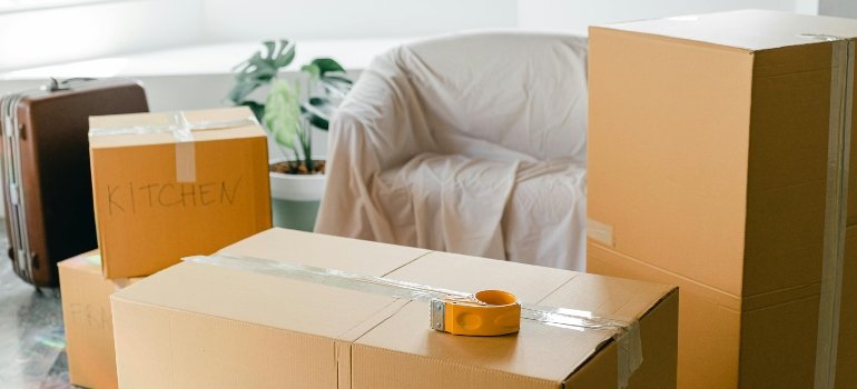 Cardboard boxes ready for moving arranged neatly beside packed furniture, handled by professional furniture movers San Antonio.