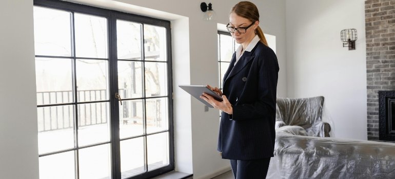 Woman in Black Blazer Holding a Tablet Computer