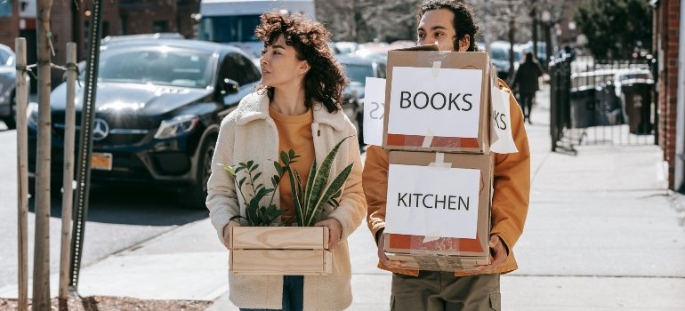 a boy and a girl holding boxes