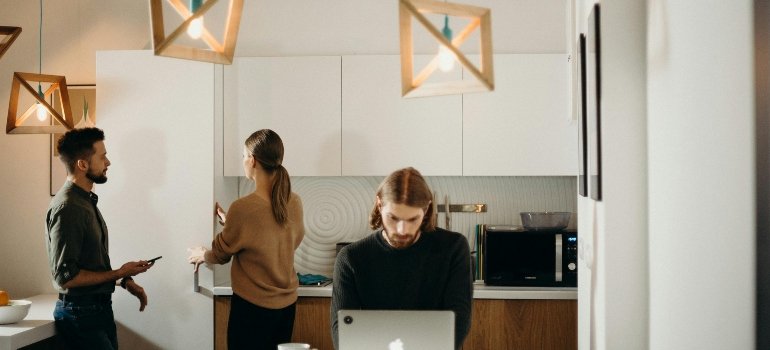 Office team discussing relocation plans in a modern workspace while using a business move checklist for organization.