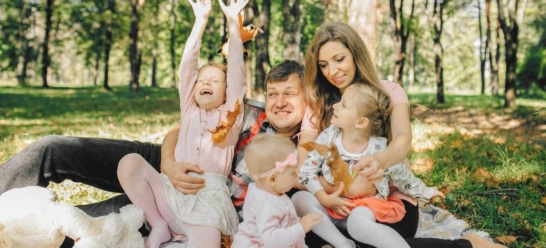 Happy Family on a Picnic Blanket and Home routines that help families maintain balancing work and family life in Kerrville.