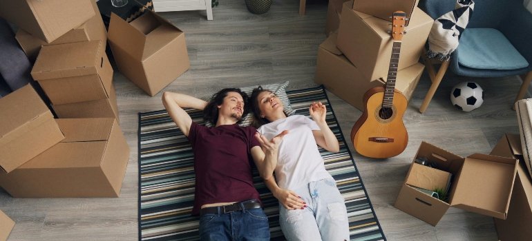 Couple Lying Down on Carpet in Room