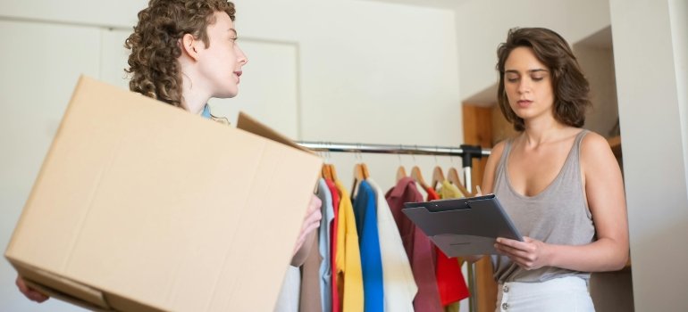 Person reviewing a moving checklist and boxes while estimating the cost of moving in Cibolo.