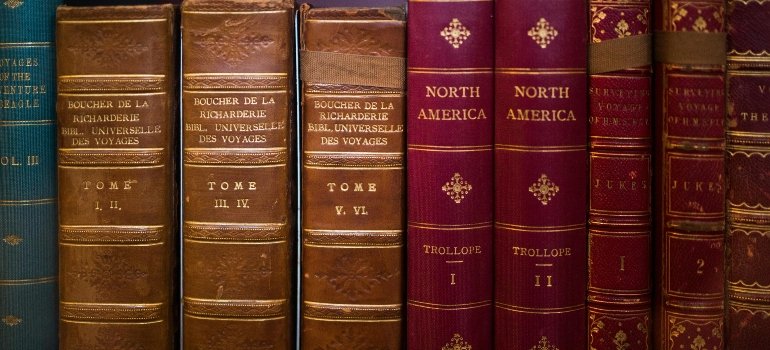 Stack of hardcover books arranged carefully before homeowners pack books for moving in Helotes.